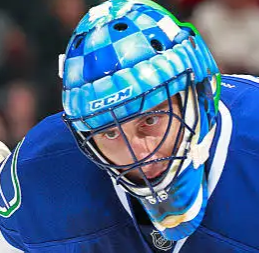 Goalie wearing the mask in a reference photo for Roberto Luongo Signed Goalie Mask 2013 Vancouver Signature Edition Tribute. Goalie Mask Collector.