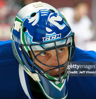 Goalie wearing the mask in a reference photo for Roberto Luongo Signed Goalie Mask 2014 Vancouver Signature Edition Tribute. Goalie Mask Collector.