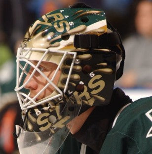 Goalie wearing the mask in a reference photo for Ron Tugnutt Signed Goalie Mask Dallas Signature Edition. Goalie Mask Collector.