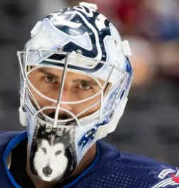 Goalie wearing the mask in a reference photo for Connor Hellebuyck Signed Goalie Mask 2024 Winnipeg Signature Edition. Goalie Mask Collector.