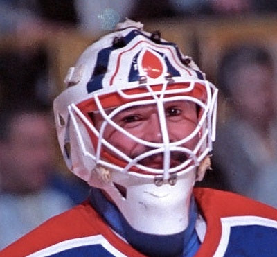 Goalie wearing the mask in a reference photo for Grant Fuhr Signed Goalie Mask Edmonton V3 1990 Signature Edition. Goalie Mask Collector.