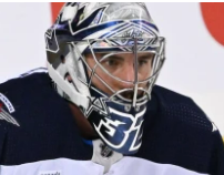 Goalie wearing the mask in a reference photo for Connor Hellebuyck Signed Goalie Mask 2022 23 Winnipeg Signature Edition. Goalie Mask Collector.