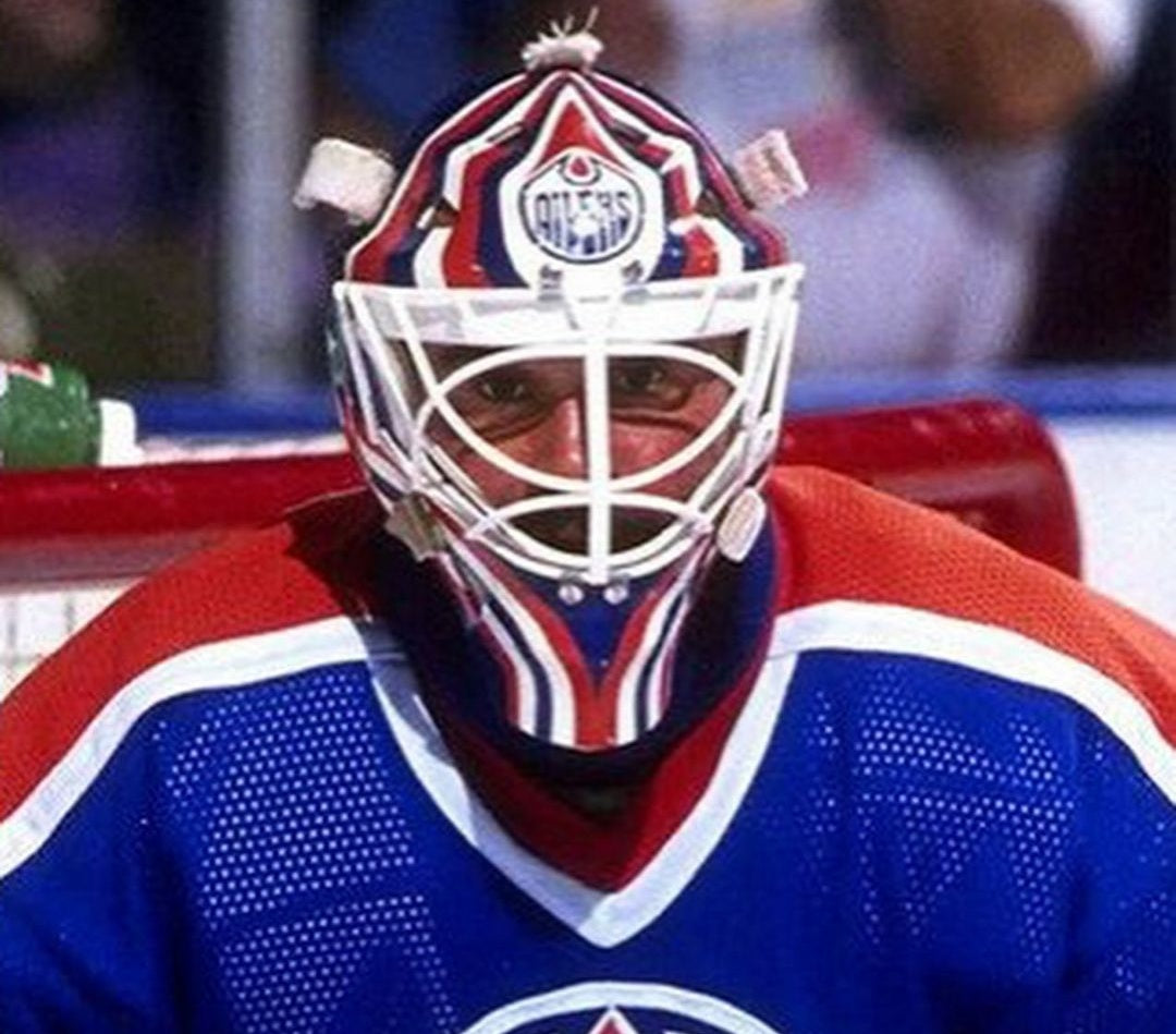 Goalie wearing the mask in a reference photo for Grant Fuhr Signed Goalie Mask Edmonton V2 1988 89 Signature Edition. Goalie Mask Collector.